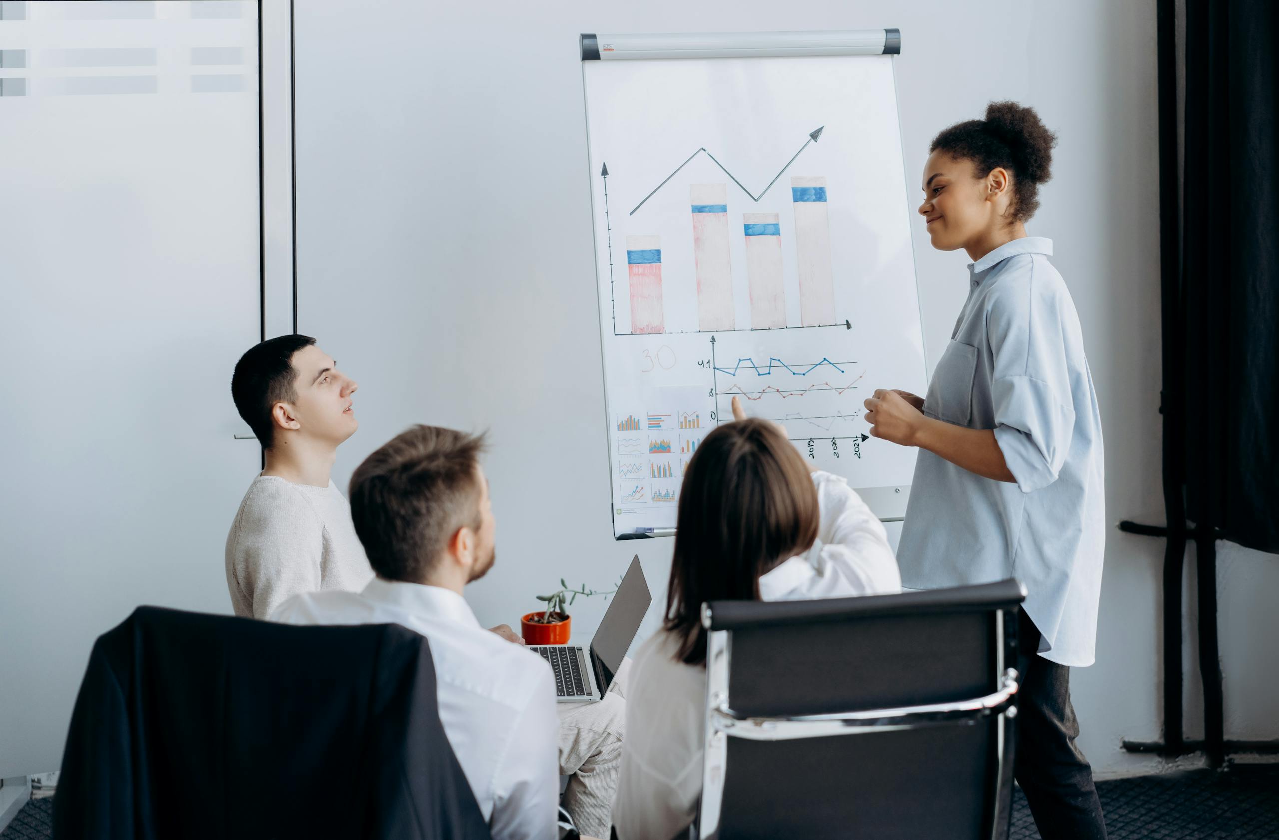 Aerial shot of a worker in a soap factory organizing bars of soap on production lines.